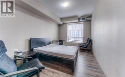 Bedroom with hardwood / wood-style flooring and a textured ceiling - 