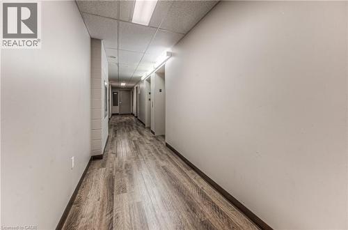 Hall featuring wood-type flooring and a paneled ceiling - 8 Hickory Street W Unit# 401, Waterloo, ON - Indoor Photo Showing Other Room