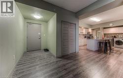 Entrance foyer featuring dark wood-type flooring and washer / dryer - 