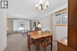 Carpeted dining room featuring a chandelier - 