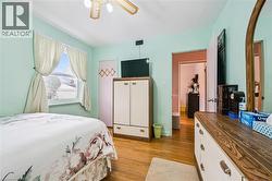 Bedroom featuring light wood-type flooring and a ceiling fan - 