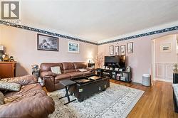 Living area featuring arched walkways and wood finished floors - 