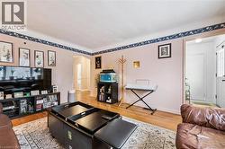 Living area with arched walkways and light wood-style flooring - 