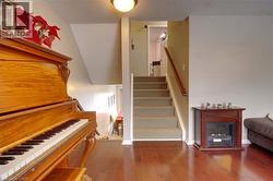 Stairway with hardwood / wood-style floors, a fireplace, and a textured ceiling - 