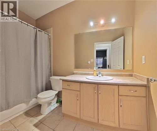 Full bathroom featuring vanity, light tile patterned floors, and shower / bath combo with shower curtain - 206 Westmeadow Drive, Kitchener, ON - Indoor Photo Showing Bathroom