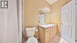 Full bath with vanity, a shower with shower curtain, and light tile patterned flooring - 