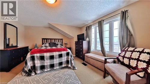 Bedroom featuring a textured ceiling and light colored carpet - 206 Westmeadow Drive, Kitchener, ON - Indoor Photo Showing Bedroom