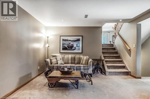Living room featuring light carpet and stairway - 2 Falls Crescent, Simcoe, ON - Indoor