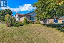 View of front of home featuring brick siding, a front yard, and an attached garage - 2 Falls Crescent, Simcoe, ON  - Outdoor 
