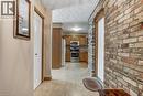 Hall with brick wall and light tile patterned floors - 2 Falls Crescent, Simcoe, ON  - Indoor 