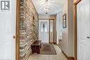 Entryway with a chandelier, tile patterned floors, and brick wall - 2 Falls Crescent, Simcoe, ON  - Indoor Photo Showing Other Room 