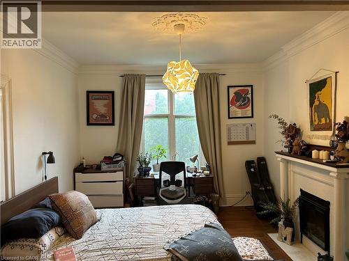 207 Charlton Avenue W Unit# Main, Hamilton, ON - Indoor Photo Showing Bedroom With Fireplace