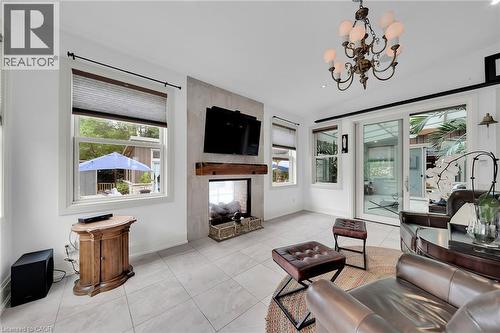 Living area with tile patterned floors, plenty of natural light, and a chandelier - 404 Mountain Brow Boulevard E, Hamilton, ON - Indoor Photo Showing Other Room With Fireplace