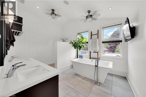 Bathroom featuring tile walls, double vanity, a soaking tub, walk in shower, and light tile patterned floors - 404 Mountain Brow Boulevard E, Hamilton, ON - Indoor Photo Showing Other Room