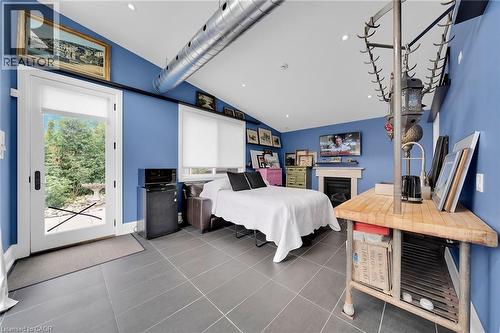 Tiled bedroom with vaulted ceiling, recessed lighting, fridge, and access to exterior - 404 Mountain Brow Boulevard E, Hamilton, ON - Indoor