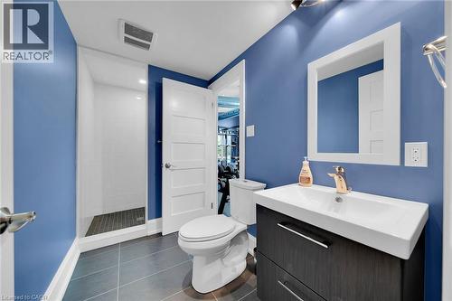 Full bath featuring dark tile patterned flooring, vanity, and a shower stall - 404 Mountain Brow Boulevard E, Hamilton, ON - Indoor Photo Showing Bathroom