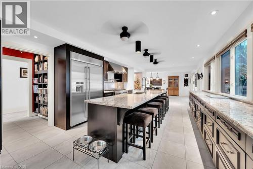 Kitchen featuring a breakfast bar, built in fridge, light stone countertops, recessed lighting, and a large island - 404 Mountain Brow Boulevard E, Hamilton, ON - Indoor Photo Showing Kitchen With Upgraded Kitchen