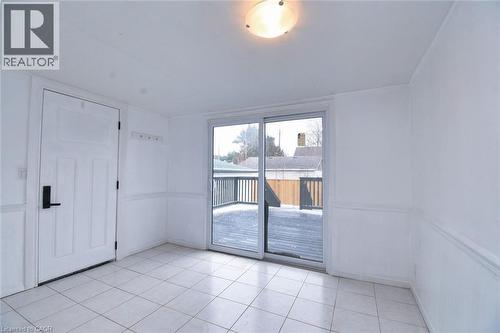 Sunroom featuring light tile patterned floors - 215 Walter Avenue S, Hamilton, ON - Indoor Photo Showing Other Room