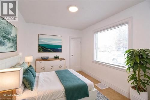Bedroom staged with baseboards and carpet flooring - 215 Walter Avenue S, Hamilton, ON - Indoor Photo Showing Bedroom