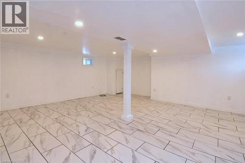 Finished basement with recessed lighting and light marble finish flooring - 215 Walter Avenue S, Hamilton, ON - Indoor