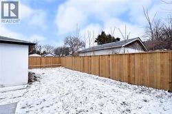 Snowy yard featuring a fenced backyard - 