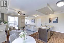 Dining space featuring ceiling fan, dark wood finished floors, crown molding, and recessed lighting - 