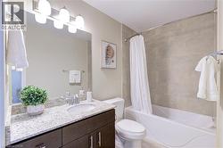 Full bathroom featuring vanity and shower / bath combo - 