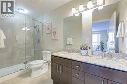 Full bath with double vanity, light tile patterned floors, and a stall shower - 