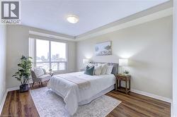Bedroom with dark wood finished floors, a view of city, and a textured ceiling - 