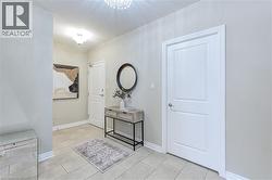 Foyer featuring light tile patterned floors and a chandelier - 