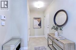Doorway to outside with tile patterned flooring and baseboards - 