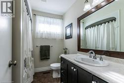 Full bath featuring vanity and curtained shower - 