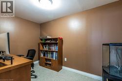 Office space with light colored carpet and baseboards - 