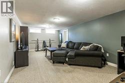 Living area with a textured ceiling and light colored carpet - 