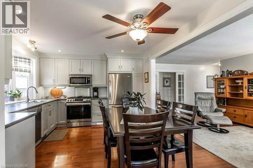 Kitchen with stainless steel appliances, dark wood-style floors, ceiling fan, gray cabinets, and recessed lighting - 22 Redwing Road, Hamilton, ON - Indoor