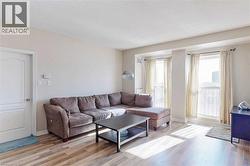 Living room featuring hardwood / wood-style flooring and a textured ceiling - 