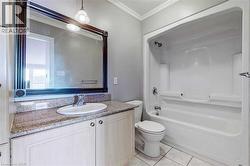 Full bathroom with vanity, bathing tub / shower combination, crown molding, tile patterned flooring, and toilet - 