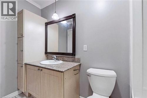 Bathroom featuring vanity, toilet, and crown molding - 135 James Street Unit# 608, Hamilton, ON - Indoor Photo Showing Bathroom