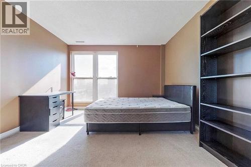 Bedroom featuring light carpet and a textured ceiling - 135 James Street Unit# 608, Hamilton, ON - Indoor Photo Showing Bedroom
