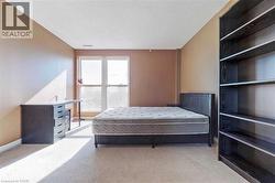 Bedroom featuring light carpet and a textured ceiling - 