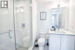 Full bathroom featuring vanity, a stall shower, and light tile patterned floors - 