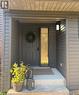 Doorway to property with covered porch - 657 Windham Road 14, Simcoe, ON  - Outdoor With Exterior 