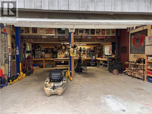 heated with wood stove - 657 Windham Road 14, Simcoe, ON - Indoor Photo Showing Garage