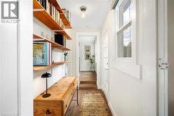 Doorway with wood finished floors and baseboards - 