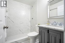 Full bathroom with vanity and a marble finish shower - 