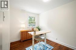 Home office featuring dark wood finished floors - 