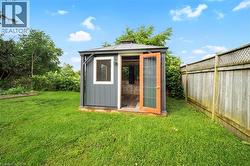 View of outdoor structure featuring a fenced backyard - 