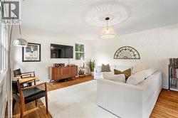 Living room featuring wood finished floors and baseboards - 