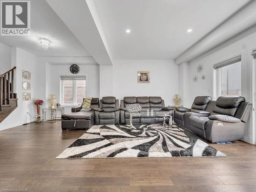 Living area featuring hardwood / wood-style flooring, stairs, and recessed lighting - 30 Times Square Boulevard, Hamilton, ON - Indoor Photo Showing Living Room