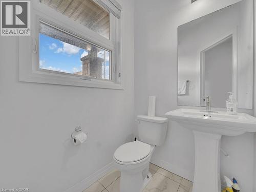Half bath with toilet and baseboards - 30 Times Square Boulevard, Hamilton, ON - Indoor Photo Showing Bathroom